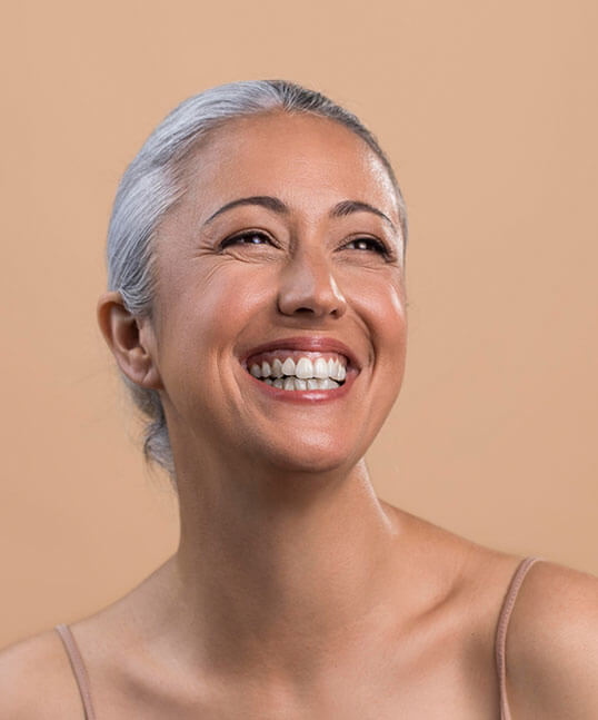 Woman smiling after regenerative facial treatment from Beauty & Health by Liz in Tucson