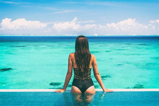 Woman in pool with Radiesse Non-surgical Brazilian butt lift from Beauty & Health by Liz