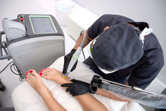 Doctor performing spider vein removal in Tucson at Beauty & Health by Liz