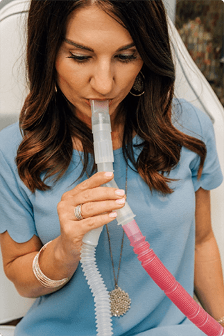 Woman inhaling Pro-Nox at Beauty & Health by Liz